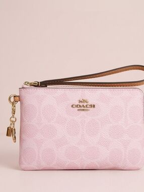 Coach | Corner Zip Wristlet in Powder Pink Signature Canvas With Flower Charm